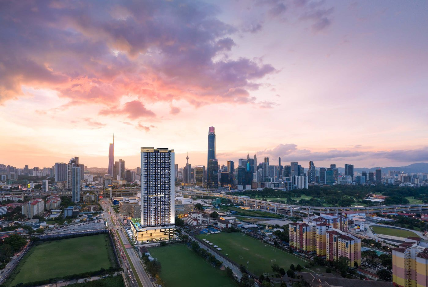 Aerial sunset render of Binastra Cochrane against the Kuala Lumpur skyline with TRX and KLCC in view (artist's impression)