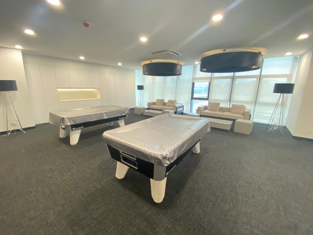 Games room with a pool table under pendant lighting