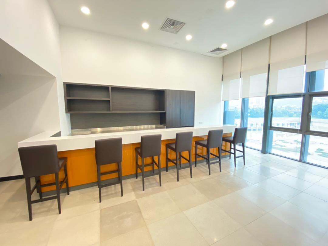 Bar and pantry counter with high stools and glazing to the city