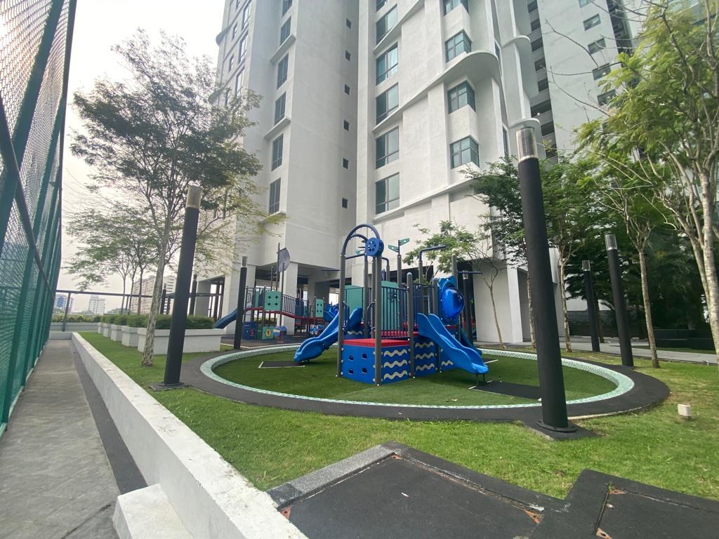 Children's playground with climbing frame and slide on a landscaped lawn