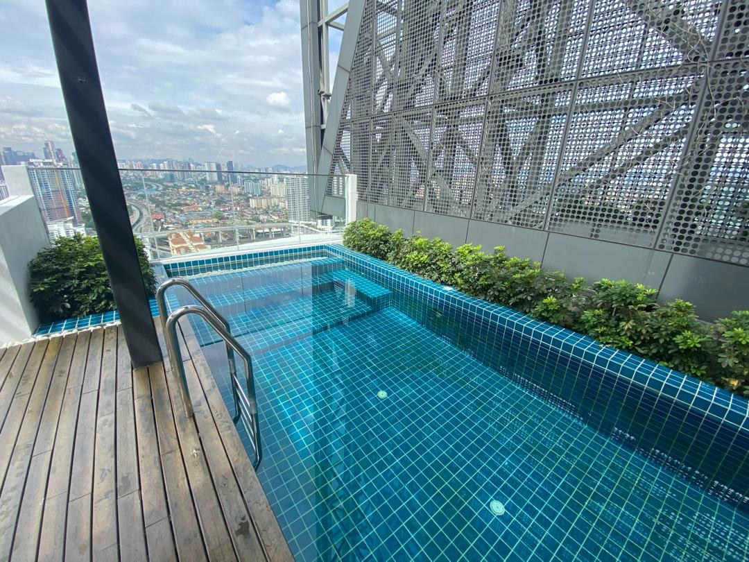Elevated swimming pool with planting and a view out over the city