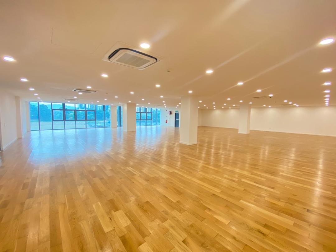 Multipurpose studio with timber flooring and mirrored wall