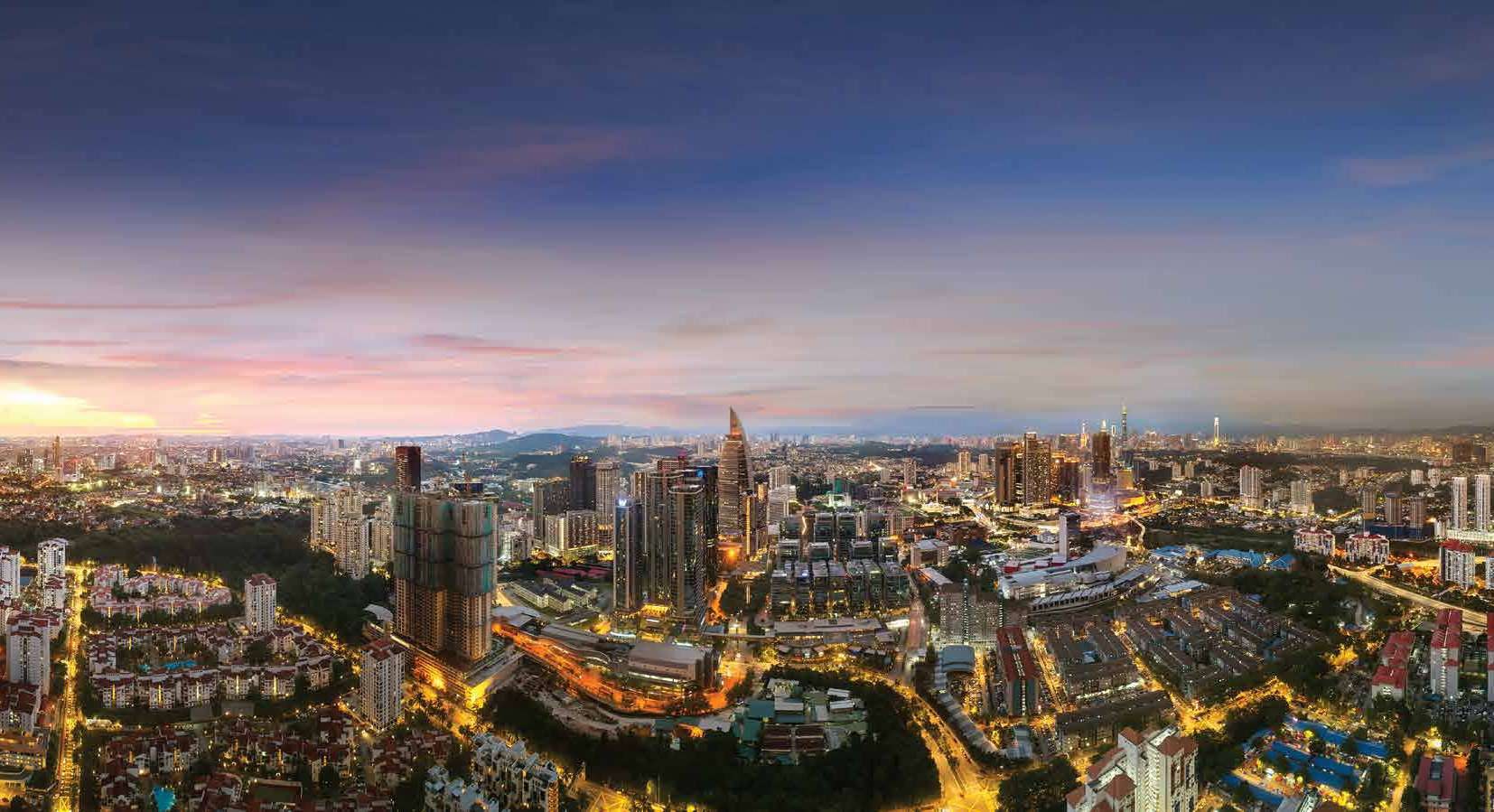 Aerial view across Bangsar South at dusk with the Kuala Lumpur skyline beyond
